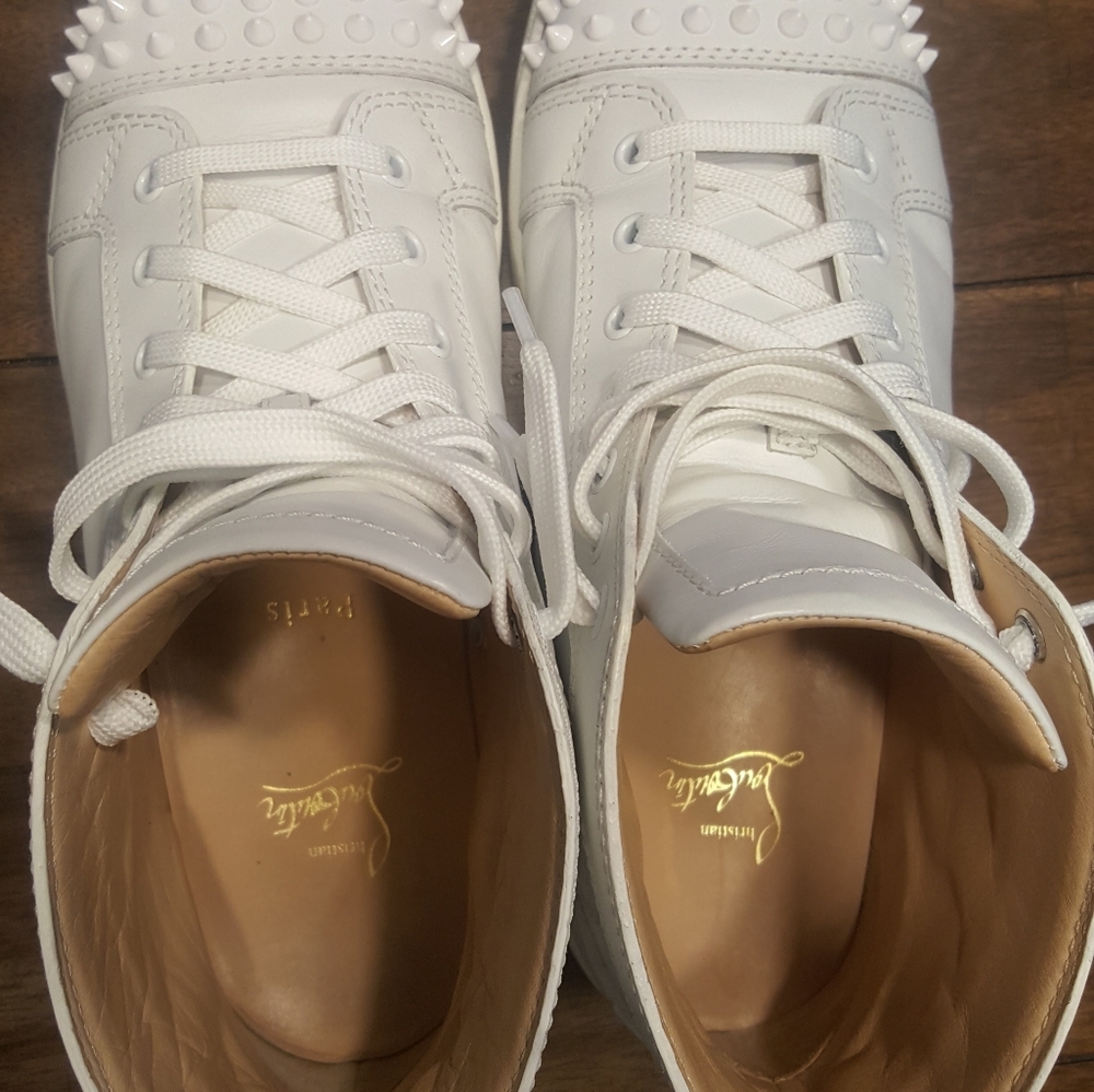Christian Louboutin white spike high-top sneaker.